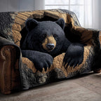 Black Bear Resting on Tan Quilt Sofa Cover