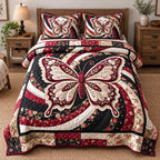 Burgundy Lace Swirl Butterfly quilted 3-piece bedding set on a made bed with two matching pillow shams