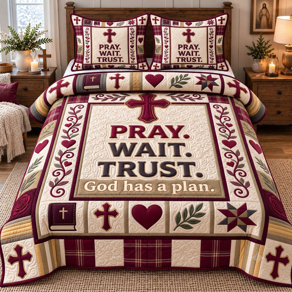 Burgundy Pray Wait Trust quilted 3-piece bedding set on a made bed in a softly lit bedroom