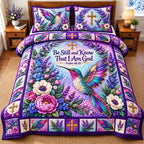 Hummingbird Floral Haven quilted 3-piece bedding set on a made bed with two matching pillow shams