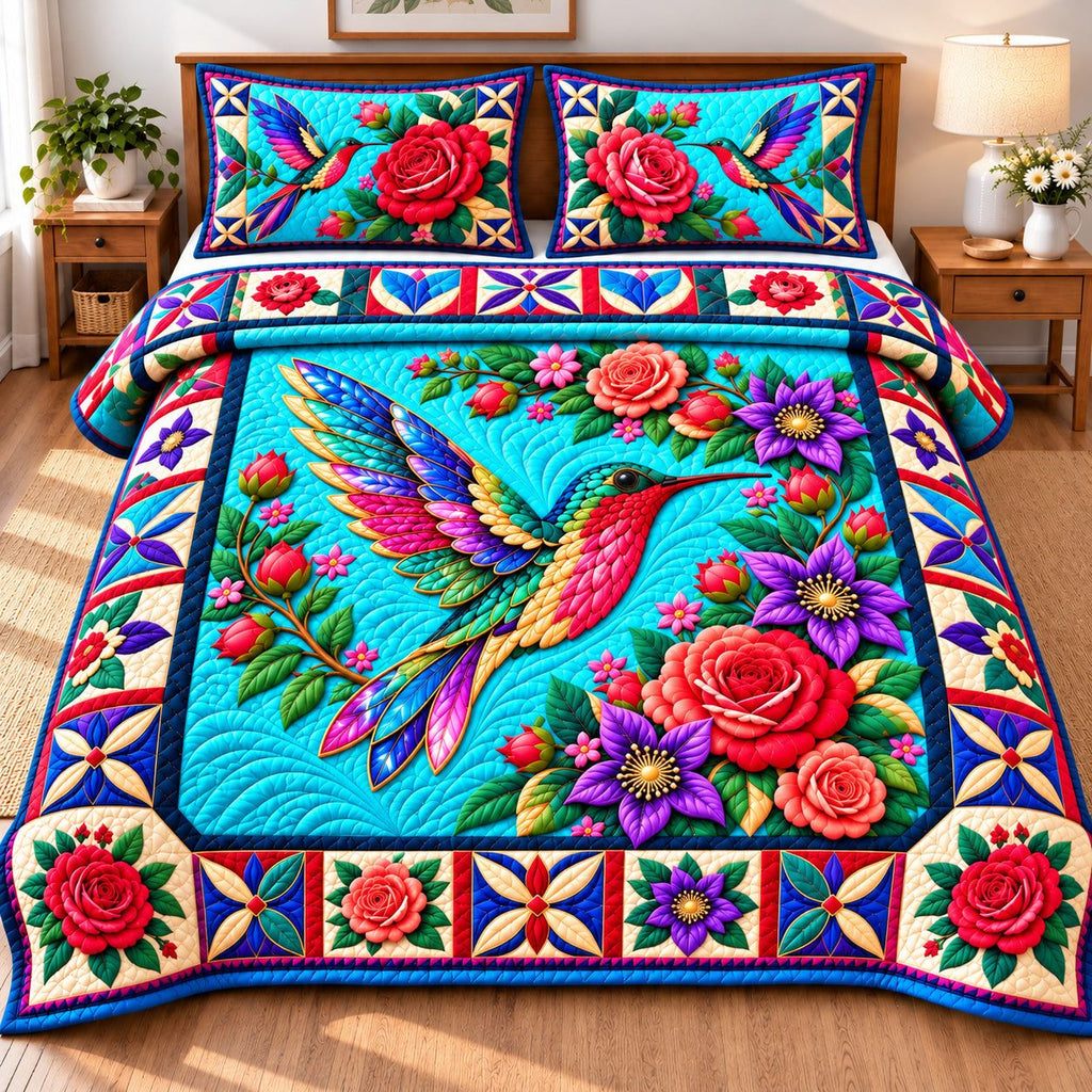 Hummingbird Garden Dance quilted 3-piece bedding set on a made bed with two matching pillow shams