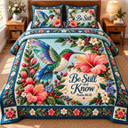 Hummingbird Garden Glow quilted 3-piece bedding set on a made bed with two matching pillow shams