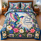 Hummingbird Summer Paradise quilted 3-piece bedding set on a made bed with two matching pillow shams
