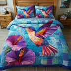 Iridescent Flutter Blue quilted 3-piece bedding set on a made bed with two matching pillow shams