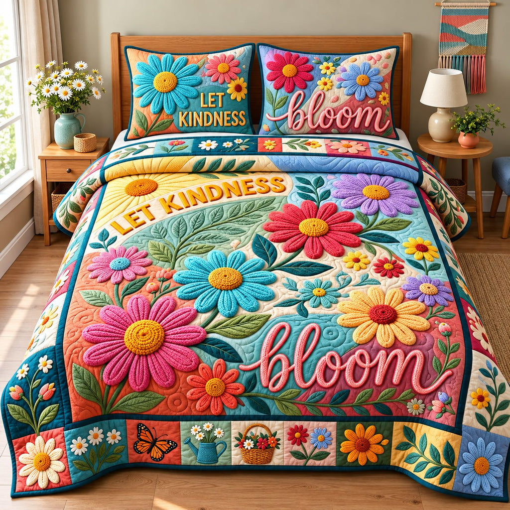 Let Kindness Bloom quilted 3-piece bedding set on a made bed with two matching pillow shams