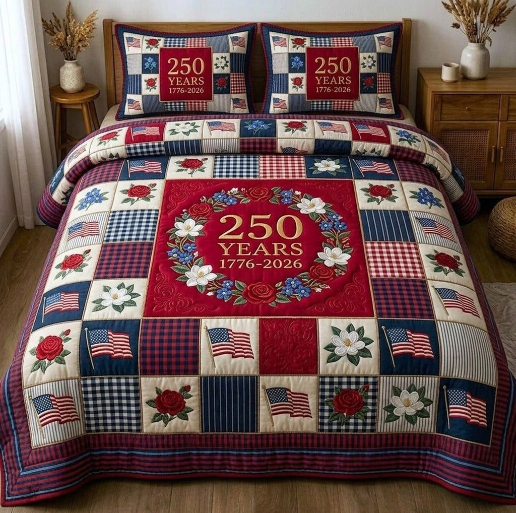 Liberty Legacy Wreath Red quilted 3-piece bedding set on a made bed in a warmly lit bedroom