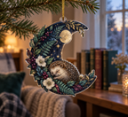 Custom contour-cut sleeping hedgehog ornament under a leafy crescent moon with gold hanging cord.