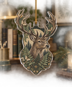 Clear acrylic stag bust ornament with fern print, top hole and gold cord.