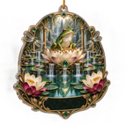 One christmas ornament with an emerald frog, luminous lotus pedestal, turquoise cascading pond, jewel dragonflies and a blank black-green plaque.