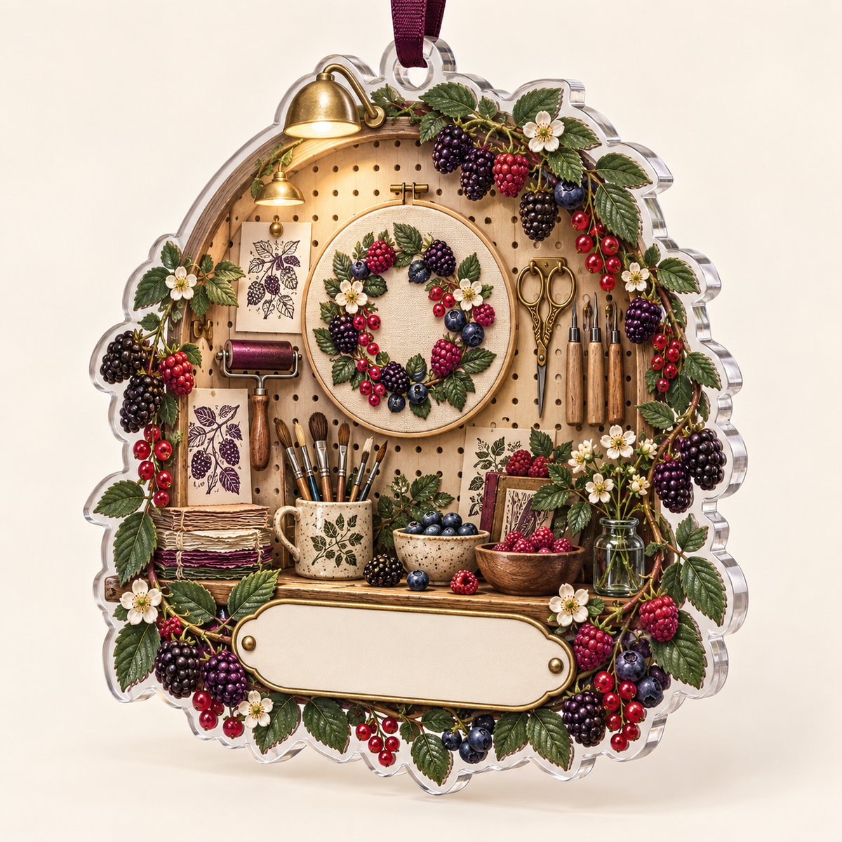 One christmas ornament with an arched craft pegboard alcove, berry-dyed yarn, a berry-wreath embroidery hoop, printmaking brayer, carving tools, brushes, brass scissors, handmade paper, blackberry, raspberry, blueberry and red-currant brambles, amber lights and a blank ivory studio plaque.