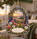 One christmas ornament with a dramatic sunrise wildflower meadow, dark-bronze botanical trellis and blank ivory name plaque.