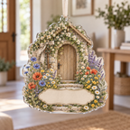 One christmas ornament with a sunlit wildflower meadow, fieldstone cottage doorway, antique-copper key motif and blank linen name plaque.