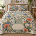One quilted bedding set with a wildflower maker garden, sea-glass studio arch, embroidery hoop, paintbrush motifs and blank oatmeal-linen name plaque.