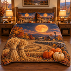 Harvest moon, golden wheat sheaves and pumpkins across one quilt and two matching shams in a warm farmhouse bedroom.