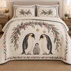 One ivory quilt and two matching shams with printed emperor penguin family, cranberry fir snowflake arch, green binding and dense quilting