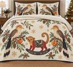 Two illustrated guira cuckoos with shaggy buff crests, yellow bills, streaked brown backs and cream-tipped long tails frame one cranberry toy rocking kinkajou with a golden-brown head, rounded ears, golden curled tail, navy saddle with ochre botanical detail and navy rocker, persimmon halves, cedar, holly, mistletoe and ochre snowflakes on ivory with navy binding. Flat printed Christmas artwork. Includes one quilt and two matching pillow shams. Dense sewn quilting, shallow fill and natural fabric drape.