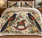 Two illustrated greater coucals with black plumage, chestnut wings, red eyes and long tails frame one navy toy rocking tenrec with a cream face, brown spiny head, cranberry saddle with ochre botanical detail and cranberry rocker, starfruit sections, cedar, holly, mistletoe and ochre stars on ivory with cranberry binding. Flat printed Christmas artwork. Includes one quilt and two matching pillow shams. Dense sewn quilting, shallow fill and natural fabric drape.