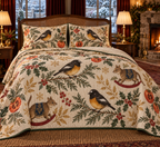 Tomtit Persimmon Rocking Bettong quilt and two matching shams flat printed black yellow birds two brown rocking bettongs persimmons green binding sewn channels natural drape in warm Christmas bedroom.