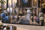 One sofa cover with a continuous hydrangea perspective salon, cobalt, cyan, orchid, coral and ivory blooms, brass frames, sculptural niches and a distant skyline terrace.