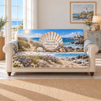 Example WELCOME / EMMA & LIAM / JUNE 15, 2026 ivory plaque before a pearlescent scallop fan on driftwood, sea lavender, dune grasses, turquoise cove and lighthouse headland.