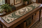 One quilted table runner with a resting deer and fern print on a collector’s console table.
