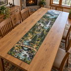 A rectangular table runner printed with a woodland adventure map, timber bridge over a rocky stream, winding trails, lookout tower and distant waterfall and mountains.