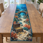 A rectangular table runner printed with an underwater treasure chest, shell-marked sandy route, coral arch and distant shipwreck.