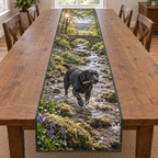 A rectangular table runner printed with a black Labrador carrying a stick through a bluebell woodland creek.