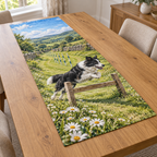 Flat printed meadow agility artwork with one border collie jumping a low hurdle, with receding weave poles and rolling hills.