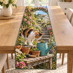 A calico cat meets a tiny frog on a turquoise watering can, with potting bench details, rose-covered garden steps and distant greenhouse.