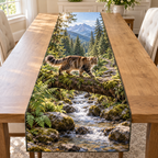 A shaggy Maine Coon walks a mossy log across a forest creek, with ferns, a small cascade, conifers and distant blue mountains.