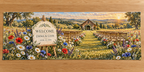 Example WELCOME / EMMA & LIAM / JUNE 15, 2026 ivory plaque on oak-style easel, daisies cornflowers poppies, empty ceremony chairs and distant barn hills.