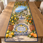 Example WELCOME / EMMA & LIAM / JUNE 15, 2026 white majolica-style welcome tablet cobalt citrus border tiled plinth lemon and orange trees terracotta pots pergola fountain Mediterranean garden villa coastal hills sky.