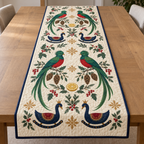 Four illustrated resplendent quetzals frame four navy toy rocking swans with ochre crowns and cranberry saddles, with lemon halves, cedar cones, holly, mistletoe and ochre snowflakes on ivory with navy binding. Flat printed Christmas artwork. Includes one table runner. Quilted cotton hero with visible sewn quilting and fabric drape.