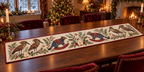 Hamerkop Pear Rocking Quoll quilted cotton table runner with flat printed birds, spotted quolls, pears and botanical stars; cranberry binding and sewn channels, shown flat on a walnut table in a warm Christmas dining room.