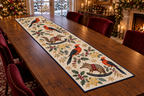 Satinbird Starfruit Rocking Numbat quilted cotton table runner four orange-red black-wing birds two striped brown rocking numbats starfruit navy binding sewn channels flat on walnut table in Christmas dining room.