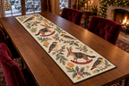 Pardalote Orange Rocking Bilby quilted cotton table runner four white-spotted yellow-throat birds two brown long-ear rocking bilbies oranges green binding sewn channels flat on walnut table in Christmas dining room.
