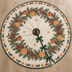 One ivory quilted Christmas tree skirt with four printed robins, orange evergreen garland, green binding, center opening and three ties
