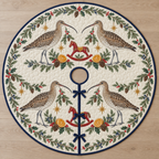 One ivory quilted circular tree skirt with four Eurasian curlews cranberry rocking horses orange slices cedar juniper holly ochre stars navy binding centered hole continuous slit three ties
