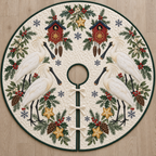 Four illustrated Eurasian spoonbills frame cranberry toy cuckoo clocks with navy roofs, starfruit slices, cedar cones, holly, mistletoe and navy snowflakes on ivory with forest green binding. Flat printed Christmas artwork. Includes one circular tree skirt with a center opening and tie closure. Visible sewn quilting and continuous radial opening.