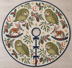 Four illustrated moss-green kakapo parrots with pale facial discs frame two gray-brown toy rocking bilbies with cranberry legs with long pink-lined ears, pointed snouts, cranberry saddles with ochre botanical detail and navy rockers, red apple halves, cedar, holly, mistletoe and ochre snowflakes on ivory with navy binding. Flat printed Christmas artwork. Includes one circular tree skirt with center opening and tie closure. Visible sewn quilting and continuous radial opening.