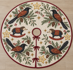 Four illustrated greater coucals with black plumage, chestnut wings, red eyes and long tails frame two navy toy rocking tenrecs with cream faces, brown spiny heads, cranberry saddles with ochre botanical detail and cranberry rockers, starfruit sections, cedar, holly, mistletoe and ochre stars on ivory with cranberry binding. Flat printed Christmas artwork. Includes one circular tree skirt with center opening and tie closure. Visible sewn quilting and continuous radial opening.