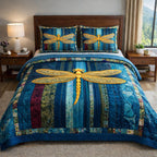Mystic Wings Dragonfly Blue quilted 3-piece bedding set on a made bed with two matching pillow shams