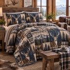 Navy Mountain Stag quilted 3-piece bedding set on a made bed in a warmly lit bedroom