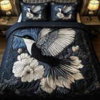 Noir Hummingbird quilted 3-piece bedding set on a made bed with two matching pillow shams