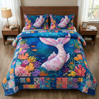Ocean Siren Tail Coral quilted 3-piece bedding set on a made bed in a light coastal bedroom