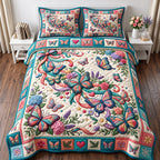 Pink Bloom Spray Patchwork Butterfly quilted 3-piece bedding set on a made bed in a farmhouse bedroom