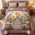 Praying Hands Without Ceasing quilted 3-piece bedding set on a made bed in a softly lit bedroom