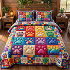 Rainbow Paw Print Blocks quilted 3-piece bedding set on a made bed with two matching pillow shams