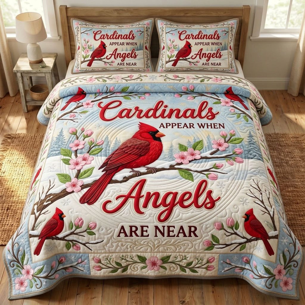 Red Cardinal Angels Near quilted 3-piece bedding set on a made bed in a softly lit bedroom